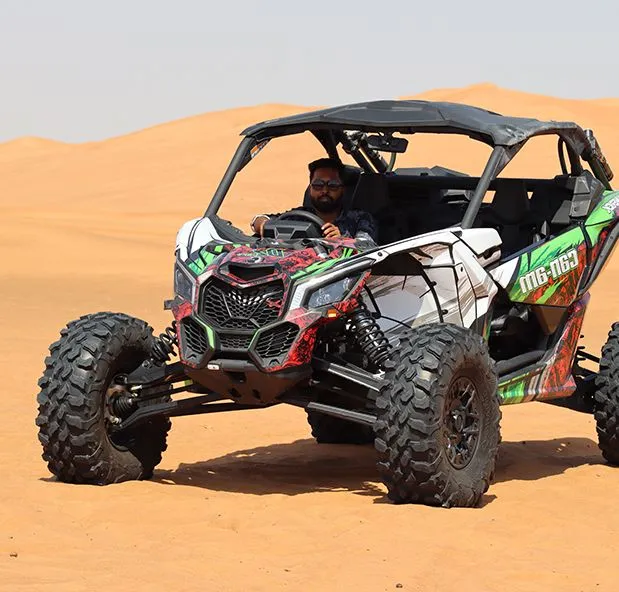 A Man in a striking Can-Am buggy rental dubai, showcasing the sporty design for thrilling off-road experiences