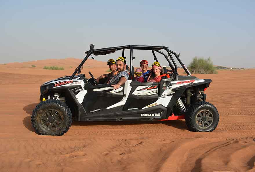 Family of five happy members enjoying and posing during a buggy tour.