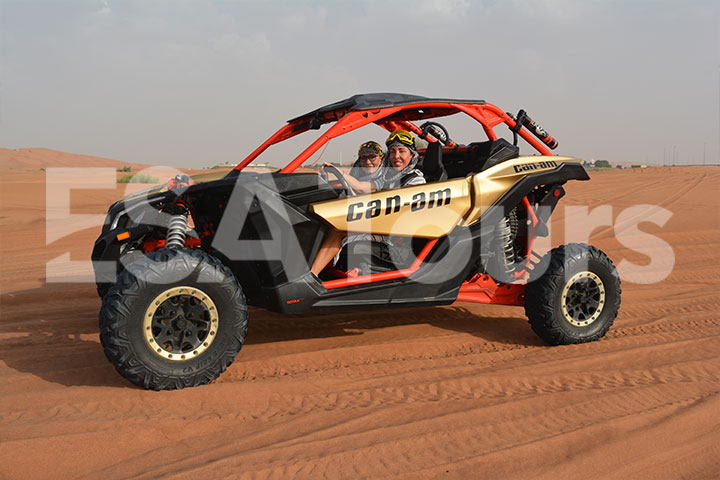 Two buddies started a Can-Am buggy ride during the daytime in a calm desert.