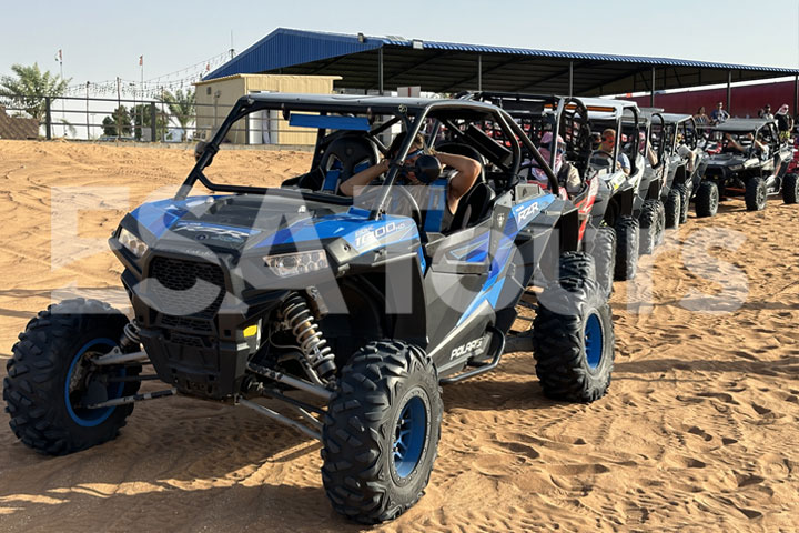 Blue and black Polaris buggies lined up, ready for a 1-hour desert ride