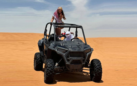 A female and a guy posing for a camera during a ride.